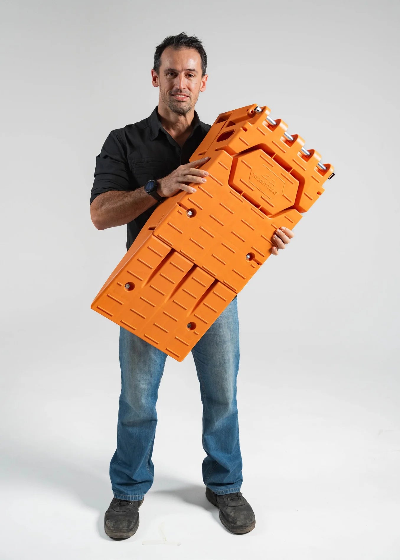 Tedd Poulos, founder of ToughTracks, holding a ramp system